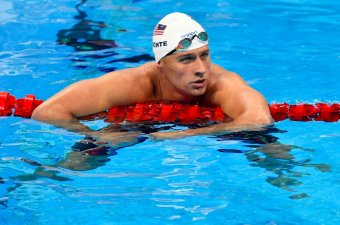 In this Aug. 9, 2016, file photo, United States' Ryan Lochte checks his time after a men' 4x200-meter freestyle relay heat during the swimming competitions at the 2016 Summer Olympics in Rio de Janeiro, Brazil. The father of the American swimmer said Wednesday, Aug. 17, his son arrived back in the United States before a Brazilian judge ordered that Lochte stay in Brazil as authorities investigate a robbery claim involving the athlete during the Olympics. (AP Photo/Martin Meissner, File)